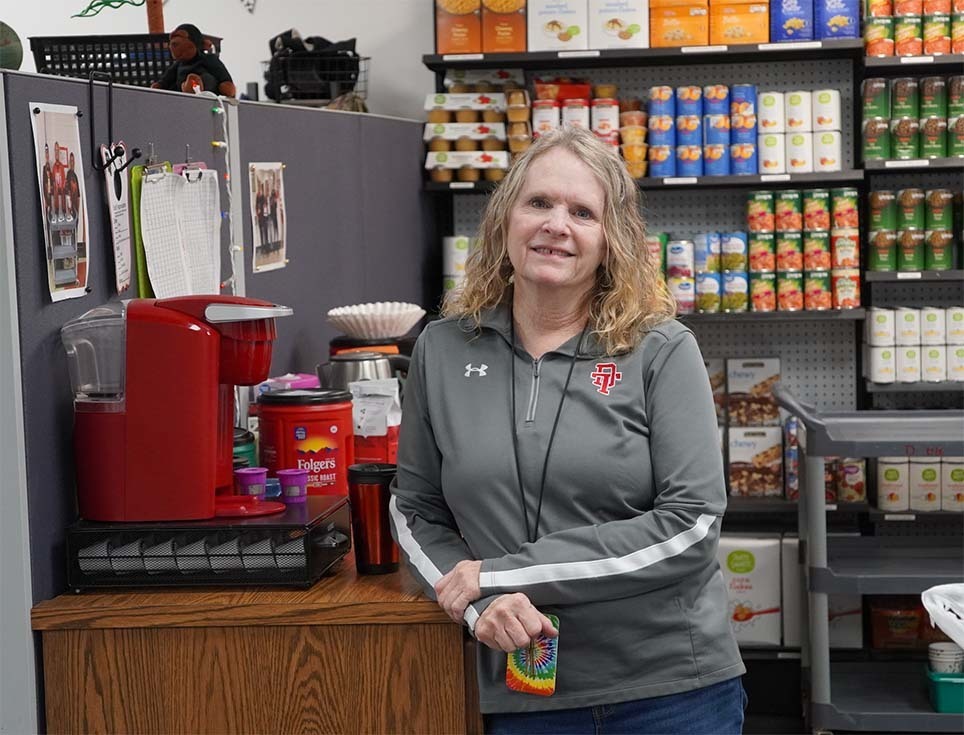 Joni Martin stands by canned goods.