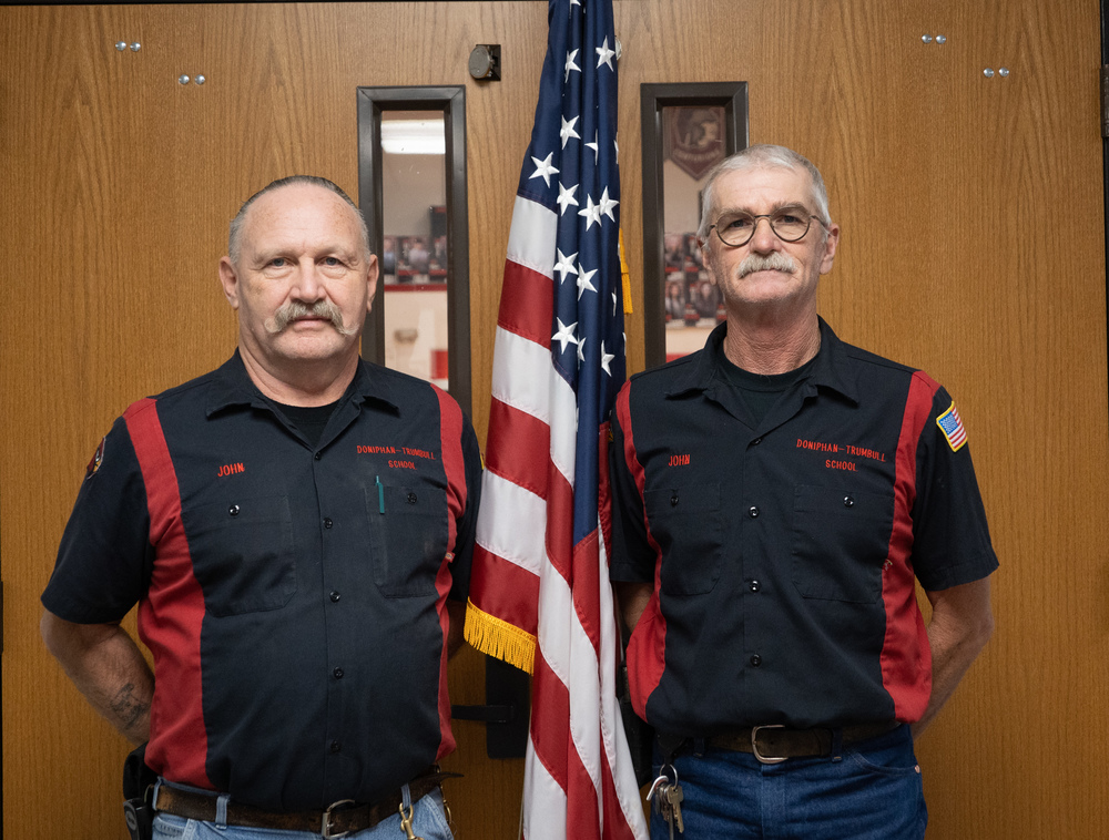 John K and John G pose by a flag.