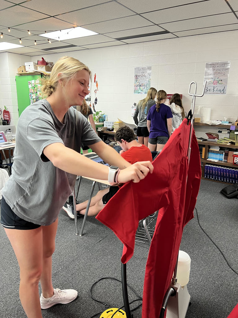 Senior Sophie Fitch steams her gown for graduation. 